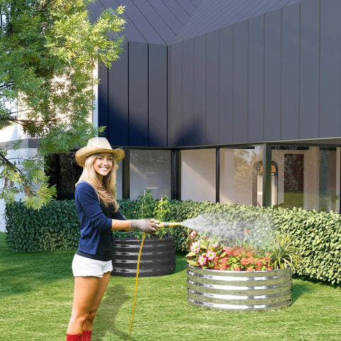 Woman watering plants in Two Pack 2x2x1 Foot Galvanized Raised Garden Bed Planter Set For Backyard Veggies And Flowers