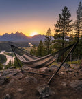 XXL Handwoven Mayan Double Hammock For Outdoor Use With Thick Cord 156 Inch Wide 90 Inch Deep And 625 Pound Capacity Heavy Duty Outdoor Hammock In Black And Natural set up on a mountain overlook at sunset.