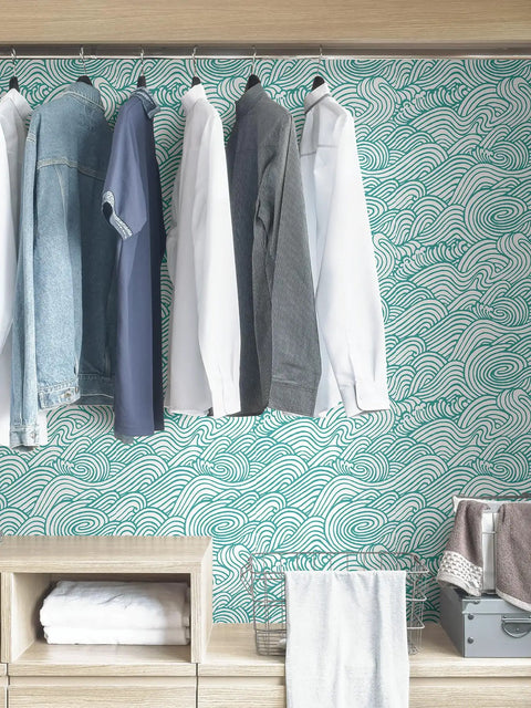 Saybrook Teal Peel And Stick Wallpaper With Aqua Wave Pattern for Renters and DIY Lovers in closet behind clothes.