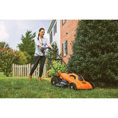 Person using a Corded Electric Push Lawn Mower With 13 Amp Motor, 20-Inch Deck, 6-Position Height Adjustment on grass.