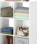 Six Cube Storage Organizer Bookcase with folded clothes, bag, and accessories on white MDF shelves for home use