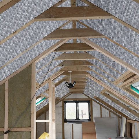 Attic interior with reflective aluminum radiant barrier sheets for Garage Door Insulation Kit With 16 Double Bubble Panels And 100 Adhesive Tape.