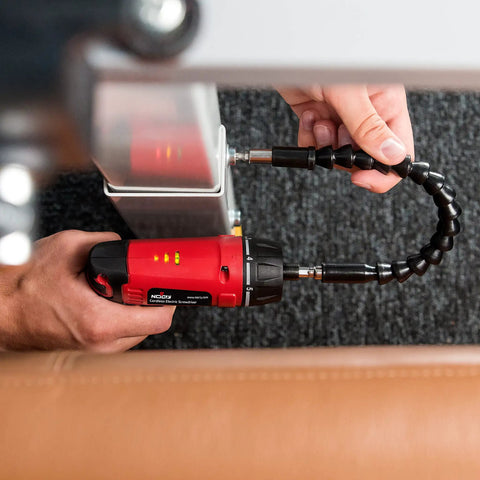 Cordless Electric Screwdriver Kit With Built In LED Light And 31 Pc Bit Set in use on furniture, showcasing flexibility and LED indicators.