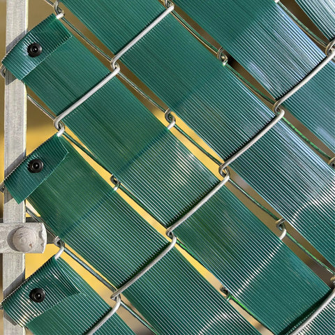 Close-up of Chain Link Fence Privacy Slats Tape Roll 250 Ft By 0.15 Ft Includes 200 Fasteners And Punch Tool UV Inhibited Green Polyethylene