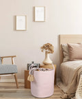 Large Tall Cotton Rope Laundry Basket Hamper With Handles For Nursery And Living Room, Woven Storage Bin in a cozy bedroom setting.