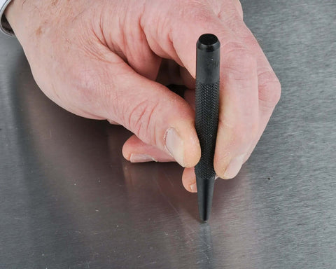 Hand using Center Punch 5 Piece Set for Metalworking, Pro Grade Chrome Alloy Steel with Hardened Ends for precise hole marking.