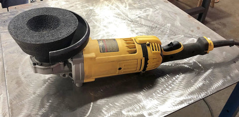 Close-up of Type 11 Flaring Cup Wheel for Metal Grinding A16 Q Tiger AO Aluminum Oxide mounted on a power tool for heavy-duty use.