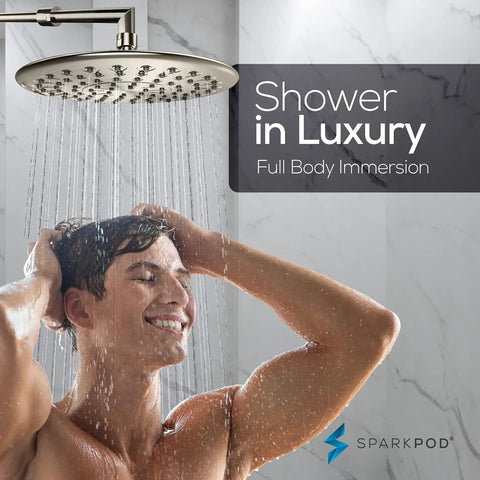 Person enjoying 9.5 Inch Large Luxury Rain Shower Head For Full Body Coverage With High Pressure Flow No Fuss Setup Anti Clog Silicone Nozzles Easy Install And No Leaks In Brushed Nickel Finish.