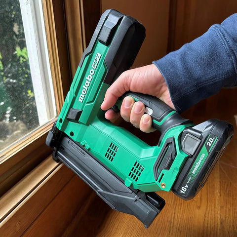 18V MultiVolt Cordless Brushless Impact Driver And 18 Gauge Brad Nailer Combo Kit in use on a window frame