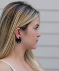 Woman wearing Spiral Fake Gauge Earrings Set in Black with Organic Wood and 316L Surgical Steel, side profile