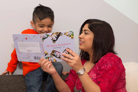Mother and child enjoying the Totally Rad Toddler Counting Book Featuring Ten Noisy Rickshaws And Hella Fun Indian Culture Educational Picture Book.