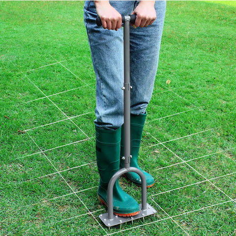 Person using Manual Lawn Aerator Spike Tool With 15 Iron Spikes for soil aeration on grassy lawn area.