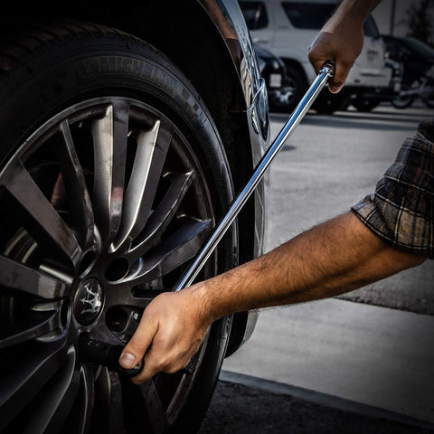 Extended Breaker Bar 40 Inch Length Three Quarter Inch Drive Heavy Duty Leverage For Frozen Nuts And Stuck Bolts in use on car wheel