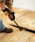 Person using 30 Inch Indexing Flat Pry Bar With 180 Degree Head And 15 Lock Positions, Raised Striking Surface to lift floorboard