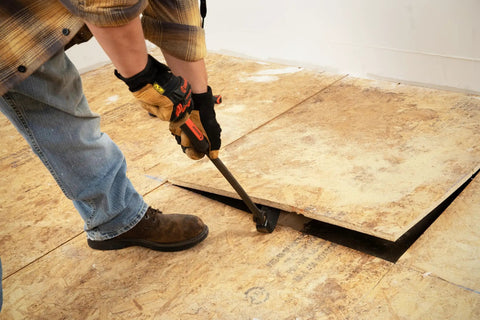 Person using 30 Inch Indexing Flat Pry Bar With 180 Degree Head And 15 Lock Positions, Raised Striking Surface to lift floorboard