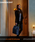 Woman standing in doorway with warm lighting from incandescent C7 night light bulb, showing cozy home atmosphere.