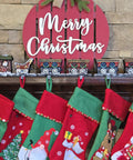 Top Shelf Cast Iron 3D Train Christmas Stocking Holder With Santa Sleigh And Four Rail Carts Six Stocking Hooks on decorated mantel