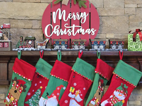 Top Shelf Cast Iron 3D Train Christmas Stocking Holder With Santa Sleigh And Four Rail Carts Six Stocking Hooks on decorated mantel