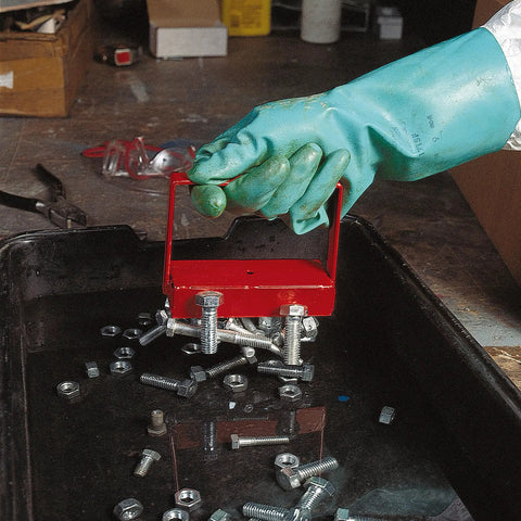 Gloved hand using red 150 lb pull heavy duty handle magnet to lift metal bolts from a tray, auto shop setting.