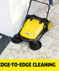 Walk Behind Outdoor Push Sweeper S 4 Twin for Workshops and Garages Cleans Up to 5 Times Faster Than a Broom, shown in use on patio.