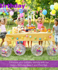 Children enjoying a party with a 22 Inch Large Happy Birthday Beach Ball With Glitter Inside For Pool Party Decor Outdoor Yard Games And Inflatable Pool Toy For Kids And Adults Party Ready Great For Summer Parties Backyard Celebrations Pool Parties And Beach Day Fun placed near a decorated table.