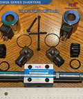 Beefy Size Six 3-Position 4-Way Hydraulic Valve With Electric Solenoid NG6, 2-Pin, 4-Port Directional Control For Mobile And Industrial Equipment, AC 110V Coil, accessories and parts layout on wooden table.