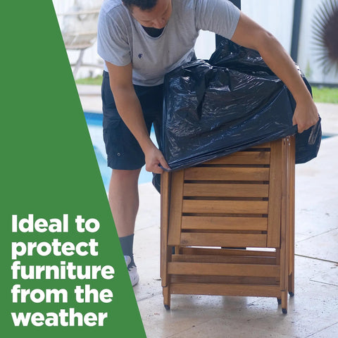 Person covering outdoor furniture with 95 Gallon Extra Large Trash Bags 61x68 Inches 1.2 Mil Thick Beefy Heavy Duty Contractor Bags