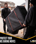 Two movers carrying a thick padded US Cargo Control 80X72 Inch Heavy Duty Moving Blanket for safe transportation.