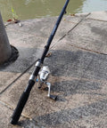 All In One Fishing Gear Kit With 2 Telescopic 6.89 Ft Rods, 2 Spinning Reels, by a waterfront on concrete