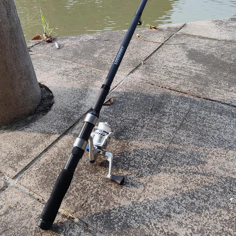 All In One Fishing Gear Kit With 2 Telescopic 6.89 Ft Rods, 2 Spinning Reels, by a waterfront on concrete