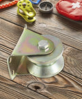 Four Piece Heavy Steel V Groove Caster Wheels For Sliding Gates And Store Doors With Precision Machined Pulley Block on wooden surface.