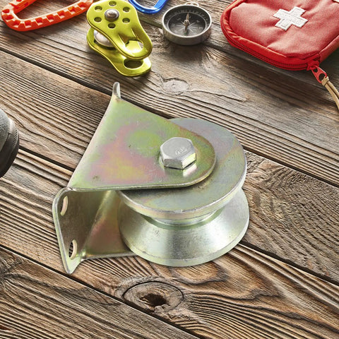 Four Piece Heavy Steel V Groove Caster Wheels For Sliding Gates And Store Doors With Precision Machined Pulley Block on wooden surface.