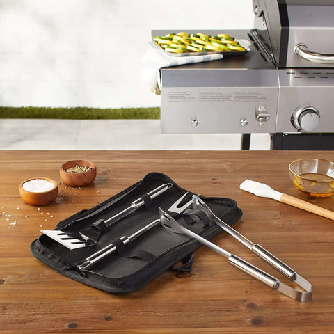 4 Piece Stainless Steel BBQ Grilling Tool Set with Carry Bag, including spatula, grill fork, tongs, and pouch, on wooden table