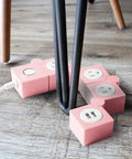 Pink Power Strip With Surge Protection, 3 AC Outlets And 2 USB Ports, Flexible Twist Design For Desk Or Floor, shows twist
