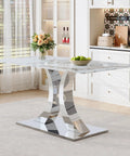 Modern dining room with marble table, chrome metal base, flowers, and fruit bowl