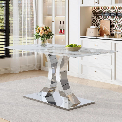 Modern dining room with marble table, chrome metal base, flowers, and fruit bowl