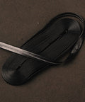 4.4 Yard Synthetic Leather Ito Tsukamaki Sageo Cord For Katana Wakizashi Tanto, black cord on textured surface