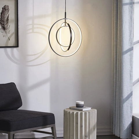 Black Modern 3 Ring Dimmable Pendant Chandelier for Dining Room, Kitchen Island, and Living Room, lit in cozy room corner.