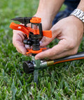 Person setting up Impulse Sprinkler With Stable Zinc Spike For Big Lawns Up To 5027 Sq Ft 80 Ft Diameter Coverage Adjustable