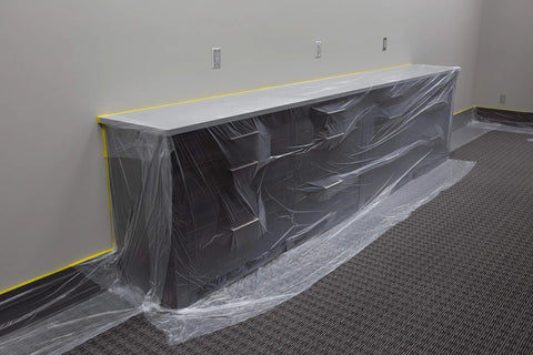 Pre Taped Masking Film With Three Quarters Inch Tape For Auto Body Protection covering a cabinet, showing film and tape application