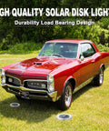 Classic red car parked on grass with Waterproof Outdoor Solar Ground Lights Disk LEDs 16 Lamp Array in garden setting