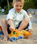 Child playing with Eco Friendly Scooper Construction Truck Toy Made From Recycled Plastic, Kid Safe For Indoor And Outdoor Play