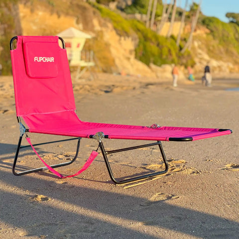 Pink 2 Leg Chaise Lounge Chair With Polyester Comfort, Reclining Back, Headrest Pillow on beach with compact frame