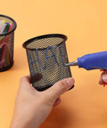 Using Glitter Hot Glue Sticks 4 By 0.27 Inch Mini Colored 48 Pack For Hot Glue Gun on mesh pen holder on orange background