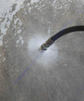 7 Pack 4000 PSI Sewer Jetter Nozzle Kit with Rotating Button Nose in use spraying water on concrete surface