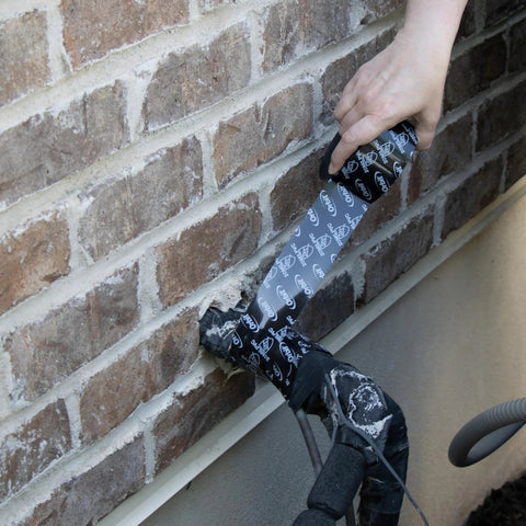 Applying Outdoor Pipe Wrap Tape 2 Inch By 50 Feet UV Resistant With Strong Adhesive Backing to outdoor pipe against brick wall