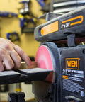 User operates Two In One Benchtop Belt And Disc Sander For The Home Workshop With Four By Thirty Six Inch Belt And Six By Six Inch Disc