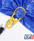 Close-up of yellow tarp clip securing blue tarp, with 'Made in the USA' text, part of 15 Pack Tarp Clips For Outdoor Camping And Shelter Setup To Hold Tents Awnings Tarps Banners And Covers With Beefy Grip And Easy Grommet Replacement Made In The USA