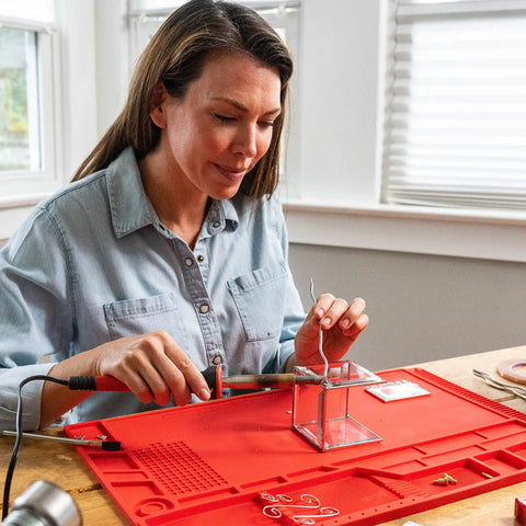 Person using Power Grip Variable Wattage Soldering Station 20 to 80W with built-in safety rest for electronics project at home