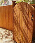 Built Different Exterior Wood Stain And Heavy Duty Fence Guard With Seriously Tough Water Repellent Finish Sierra Cedar Tint used on a wooden gate.